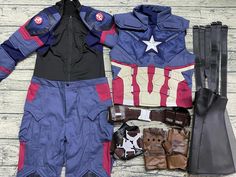 the captain costume is laid out next to gloves, gloves and other items on a wooden surface