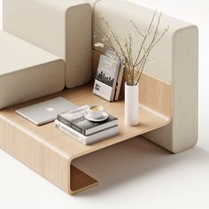 a coffee table with books and a laptop on it next to a white couch,