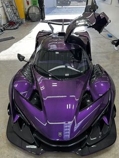 a purple sports car parked in a garage