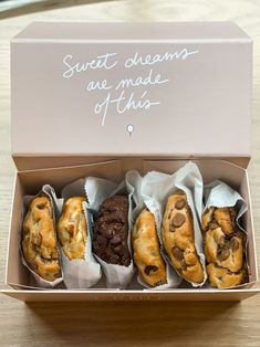 four different types of pastries are in a box on a table with the words sweet dreams are made of this