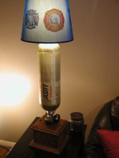 a lamp that is sitting on top of a table next to a leather couch and chair