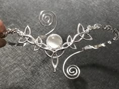 I've fabricated a truly Celtic upper arm cuff bracelet, or arm torc, in Celtic fashion with an 8mm round Moonstone shown for reference, but you can choose a myriad in the drop down menu. I designed this piece in sterling silver and an approximate size for the piece will fit most arm sizes, as you can squeeze it on for a secure fit. There's a total of 5 Trinity Knots that wonderfully matches this wedding circlet: https://www.etsy.com/listing/181351917/celtic-wedding-bridal-headpiece-circlet?ref=s Pretty Silver Bracelet, Silver Arm Jewelry, Silver Fantasy Jewelry, Arm Cuff Jewelry Silver, Fantasy Style Silver Jewelry With Unique Design, Adjustable Wire Wrapped Fantasy Jewelry, Adjustable Silver Fantasy Bracelet, Fantasy Style Silver Bracelet, Silver Fantasy Bracelet