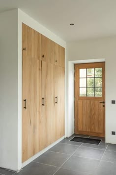 an empty room with wooden doors and tile flooring