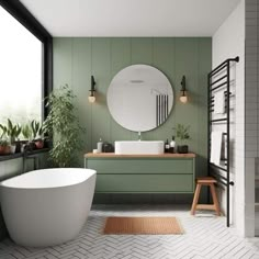 a bathroom with green and white walls, a round mirror over the bathtub and two planters on the floor