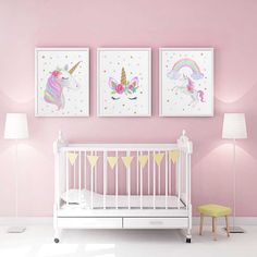 a baby's room with pink walls and two unicorns on the wall above it