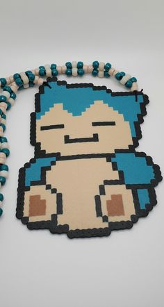 a beaded necklace with an image of a cartoon character in blue and white beads