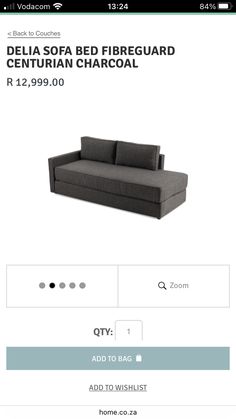 a black couch sitting on top of a white floor next to a sign that reads delta sofa