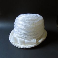 "This vintage women's white cellulosic bucket/cloche/pillbox hat featuring a 5 3/4\" width offset bow and 1 3/4\" height upturned brim is 6\" in height, 21 3/4\" around the perimeter of the interior comfort band (approximately a size 7 medium), and maintains it's original Hatters, Cap & Millinery Workers Union International tag... very 1960's." Vintage White Wide Brim Bucket Hat, Adjustable Cloche Hat For Church, Vintage White Mini Hat With Short Brim, White Adjustable Cloche Mini Hat, White Bucket Hat For Party, White Cloche Mini Hat For Church, Vintage White Cloche Hat, White Wide Brim Hat For Gift, White Bucket Hat As Gift