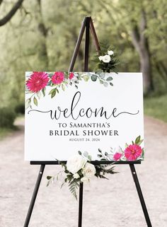 a welcome sign with flowers on it for the bride and groom to walk down the aisle