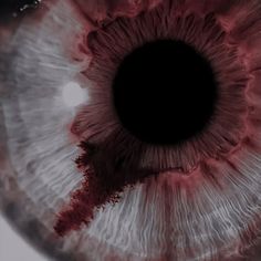 an extreme close up view of the iris of a person's eye with brown and white dye on it