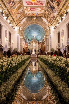 the inside of a building with flowers and paintings on the ceiling