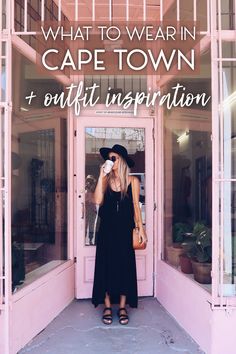 a woman standing in front of a pink building with the words what to wear in cape town