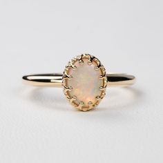 This antique style crown ring comes with a gorgeous Australian oval opal. If you want a different stone or want to add accent diamonds contact us for a quote. Details: - Default stone size is 7x5mm Australian Opal in oval shape. - Shiny finish by default. - Default width is 1.8mm at the bottom and 8.7x6.5mm at the top - Default thickness is 1.6mm at the bottom and 2mm at the top. - Contact us for quote if you want to customize this ring in any way. Thank you for shopping with Sevgi Jewelry! Elegant Opal Cabochon Ring, Classic Cabochon Opal Ring, Classic Moonstone Opal Ring For Anniversary, Classic Opal Moonstone Anniversary Ring, Classic Opal Gemstone Ring, Classic Opal Oval Cabochon Ring For Promise, Classic Opal Oval Cabochon Promise Ring, Classic Oval Cabochon Opal Promise Ring, Classic Moonstone Oval Cabochon Ring For Wedding