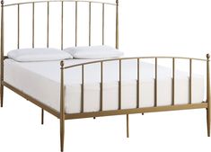 a metal bed frame with white sheets and pillows