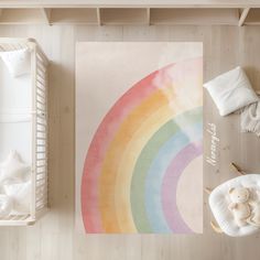 an overhead view of a baby's room with a rainbow print on the wall