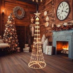 a christmas tree is lit up with lights in the middle of a room next to a fireplace