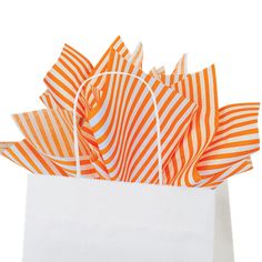 an orange and white striped gift bag on a white background with the handles folded down