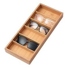 three pairs of sunglasses in a wooden box