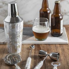 a wooden table topped with bottles and measuring spoons on top of a cutting board