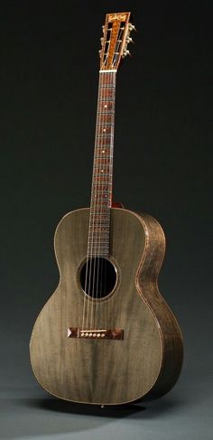 an acoustic guitar sitting on top of a table