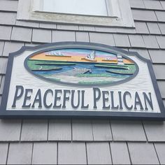 a sign on the side of a building that says peaceful pelican