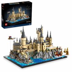 a lego hogwarts castle is shown in front of a box with its contents