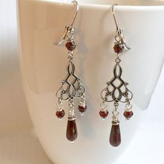 "Red and Silver Earrings - Antiqued Silver Plated Stampings with Dark Cranberry Red Czech Glass Teardrops with a Picasso finish and Faceted Dark Cranberry Red Glass Beads. These earrings are lightweight for easy wearing The earrings measure just over 2.75\" from top of earwires to bottom Antiqued Silver Plated Leverback Earwires" Red Teardrop Chandelier Earrings As Gift, Burgundy Dangle Earrings, Red Nickel-free Chandelier Earrings As Gift, Handmade Burgundy Drop Earrings, Handmade Burgundy Dangle Earrings, Elegant Red Teardrop Beaded Earrings, Nickel Free Elegant Red Chandelier Earrings, Elegant Nickel-free Red Chandelier Earrings, Red Teardrop Chandelier Earrings With Ear Wire