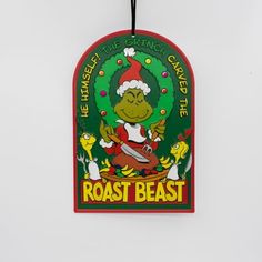 a christmas ornament hanging from the side of a wall with an image of a cartoon character on it