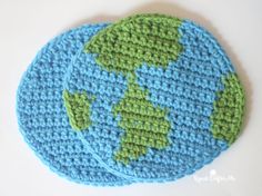 two crocheted coasters with the earth on them