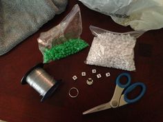 scissors, sprinkles, and other items are on the table next to some plastic bags