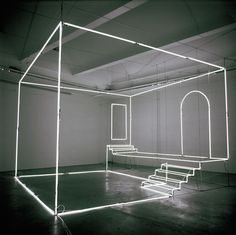 an empty room with benches in the middle and neon lights on the ceiling above it