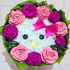 a hello kitty bouquet with pink and purple flowers in the shape of a cat's face