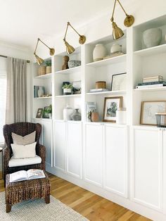 a living room filled with lots of white shelves