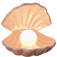 an open shell shaped bowl with a white ball in the center, on a white background