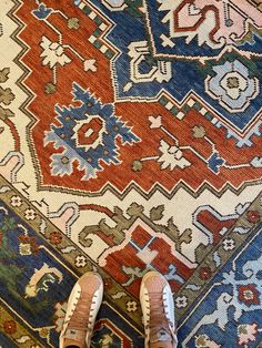 a person standing on top of a rug with their feet propped up against the carpet