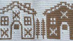 a crocheted blanket with brown and white designs on the front, along with two houses