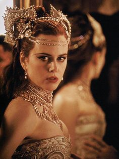 a woman wearing a tiara and looking at the camera with an intense look on her face