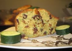 zucchini bread on a white plate with cucumbers