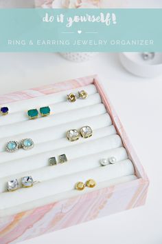 a jewelry box with six pairs of earrings in it