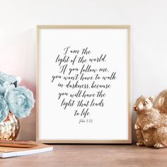 a white framed print with the bible verse on it next to a flower and pencils