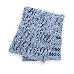 a blue crocheted dishcloth on a white background