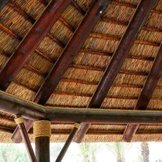 the inside of a hut with straw roof