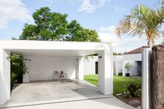 a white house with a bicycle parked in the garage