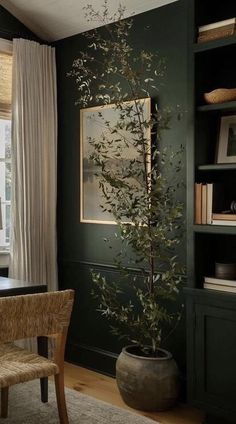 a room with green walls and a tree in the corner