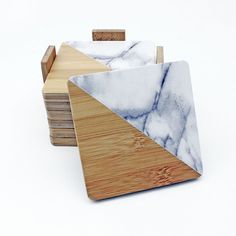 marble and wood coasters stacked on top of each other in the shape of triangles