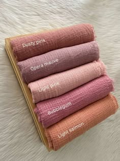 five towels stacked on top of each other in different colors and sizes, with the words dusty pink open above them