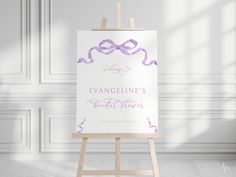 an easel with a purple ribbon on it