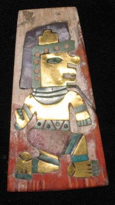 an ancient egyptian statue with gold and blue accents on it's face, sitting on a black surface