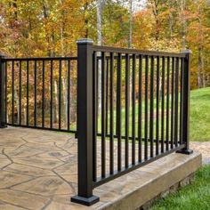 a black iron fence on a stone patio