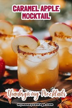 two glasses filled with apple cider cocktails on top of a wooden table next to apples